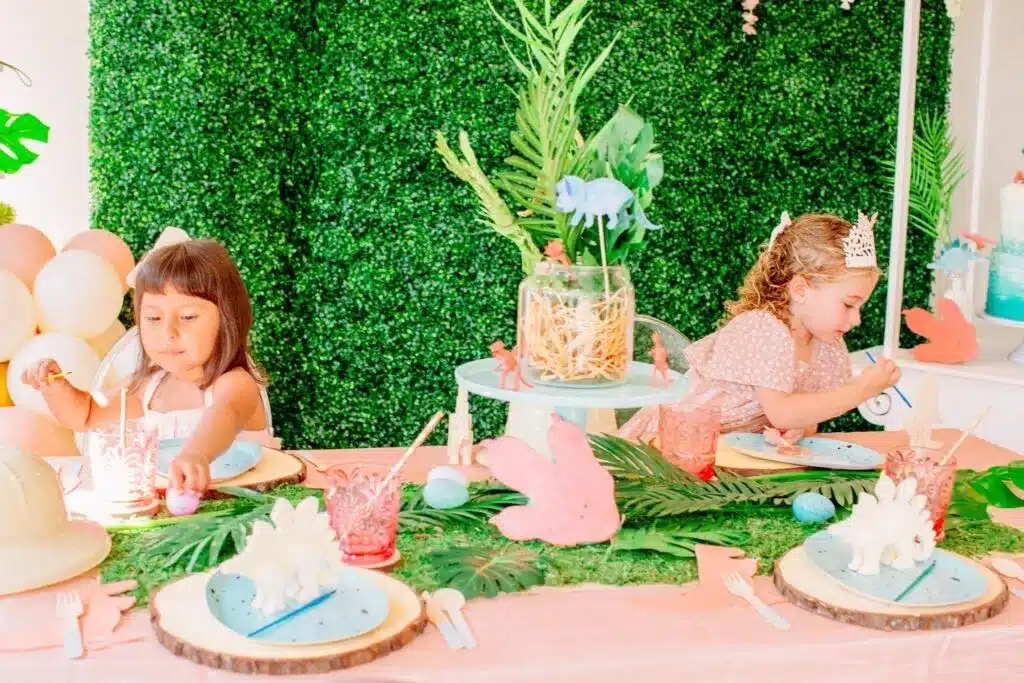 Children at themed party table with decorations and treats