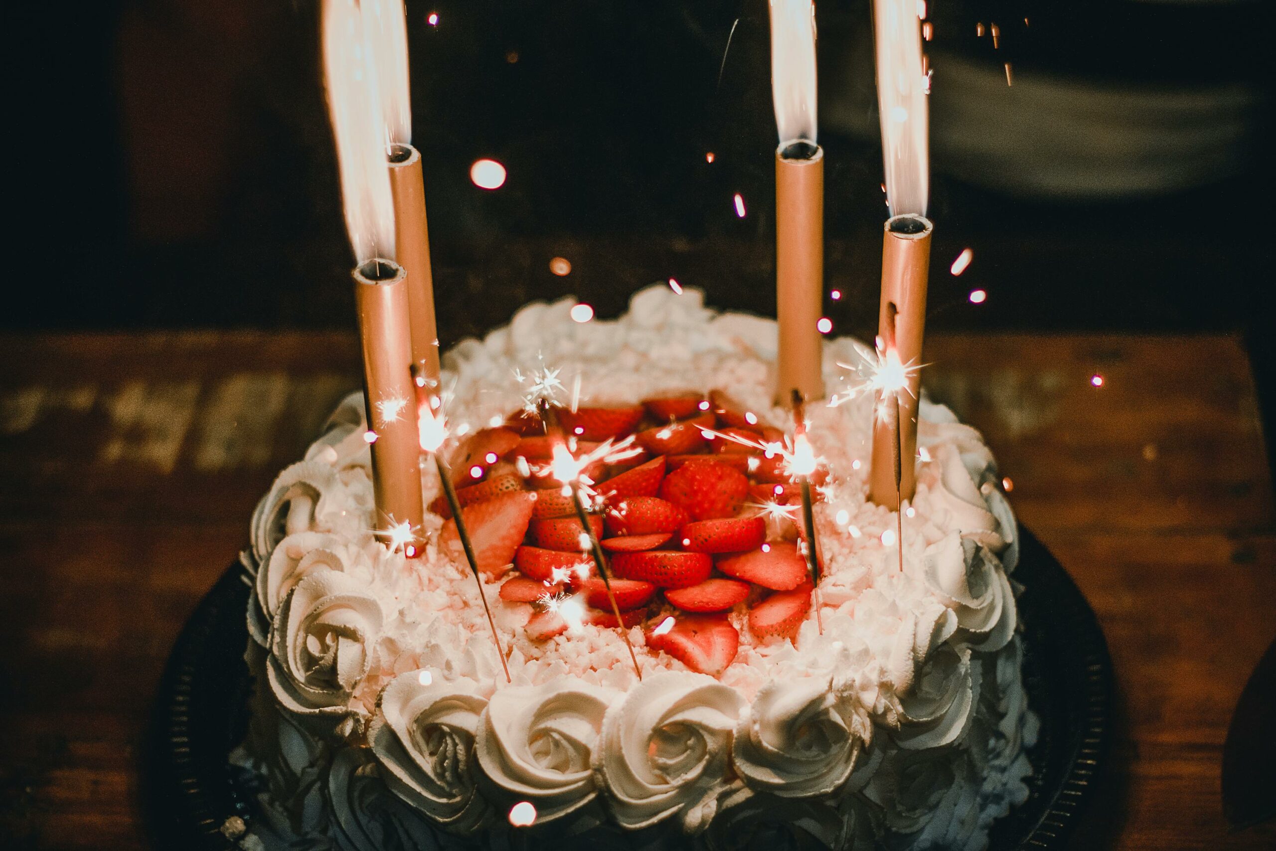 Strawberry cake with candles and sparklers on top