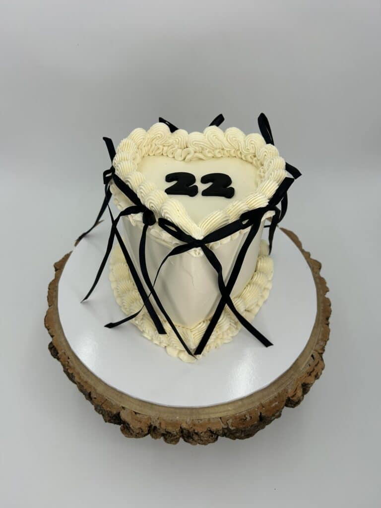 Heart-shaped cake with number 22 and black ribbon decoration