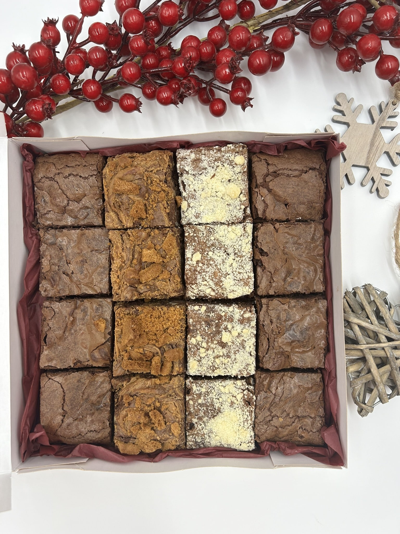 Assorted brownie squares in a gift box with festive decorations