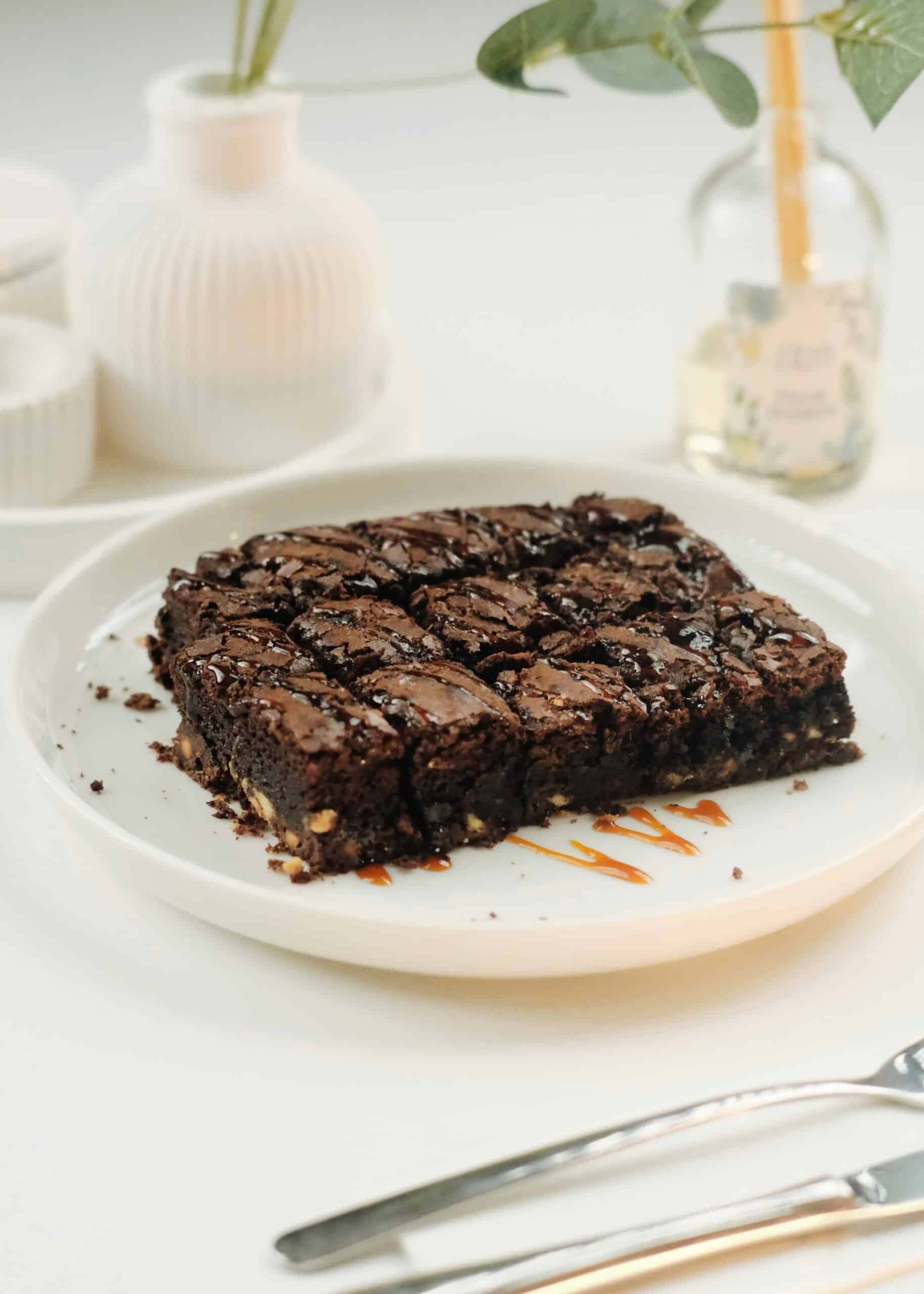 Chocolate brownie slab cut into squares on a plate