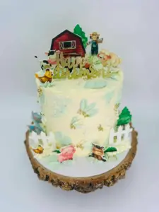 Farm themed celebration cake with animals and barn topper