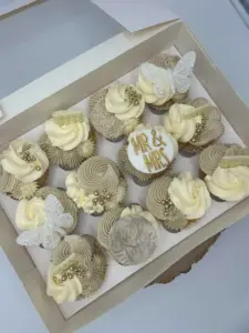 Box of wedding cupcakes with “Mr & Mrs” topper and butterfly decorations